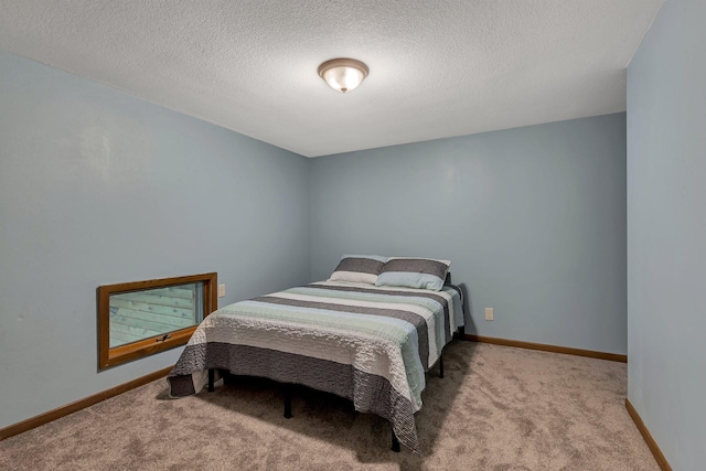 bedroom with carpet floors, a textured ceiling, and baseboards