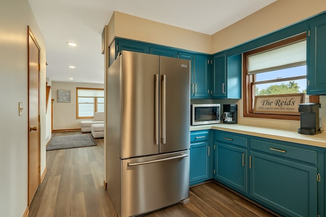 kitchen with dark wood finished floors, recessed lighting, appliances with stainless steel finishes, and light countertops