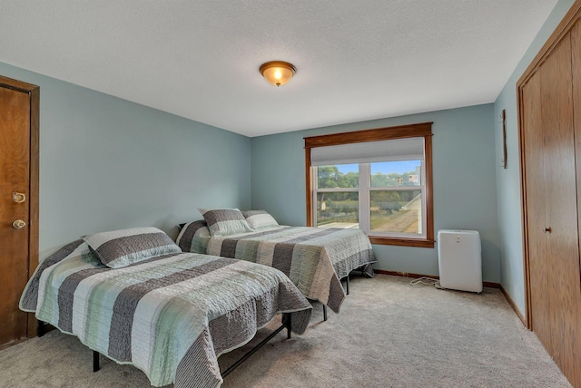bedroom with light carpet and baseboards