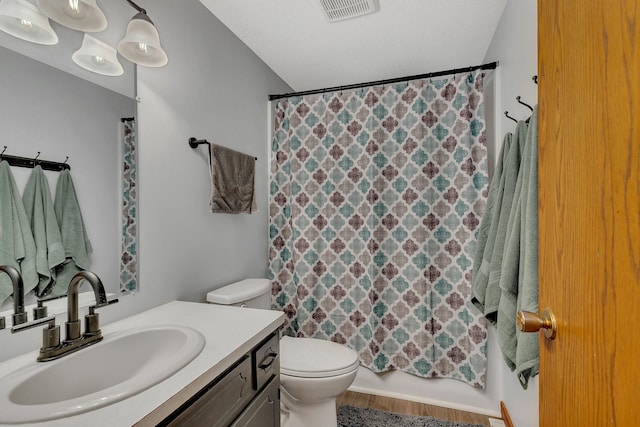 full bathroom with toilet, vanity, shower / tub combo with curtain, and visible vents