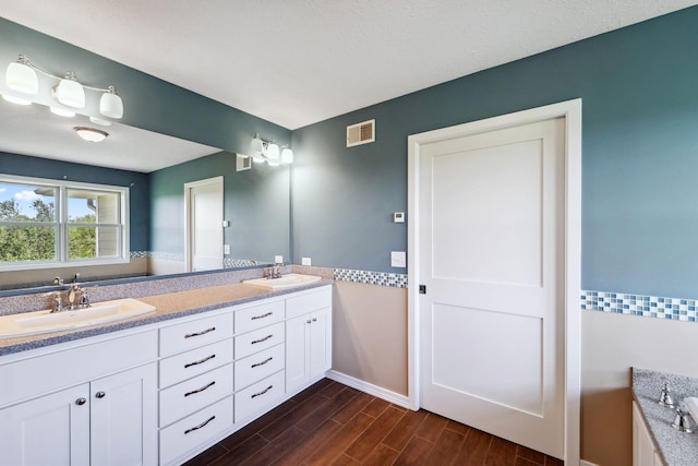 2724 Neal Ave N, West Lakeland Twp, MN 55082 - full bathroom featuring wood finished floors, baseboards, and double vanity