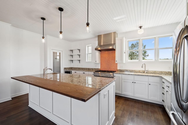 2724 Neal Ave N, West Lakeland Twp, MN 55082 - kitchen featuring wall chimney range hood, a sink, open shelves, freestanding refrigerator, and an island with sink