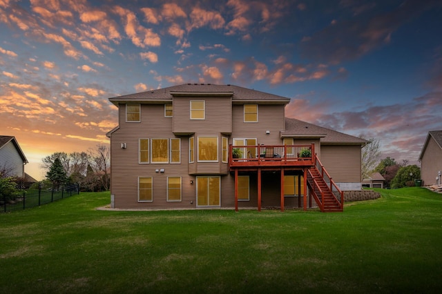 2469 Tournament Players Cir S, Blaine, MN 55449 - back of property featuring stairs, a lawn, fence, and a deck