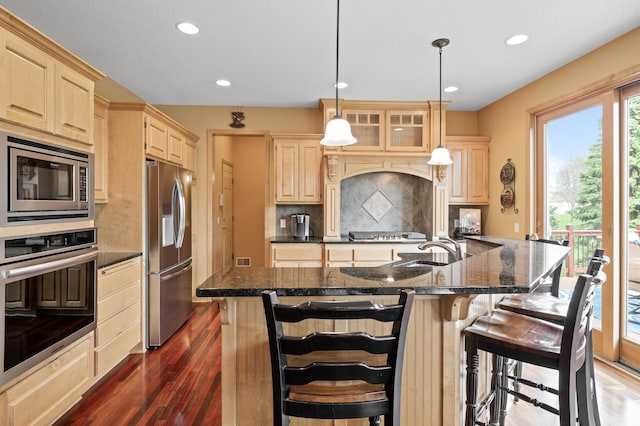 2469 Tournament Players Cir S, Blaine, MN 55449 - kitchen with decorative backsplash, light brown cabinets, dark wood-type flooring, recessed lighting, and appliances with stainless steel finishes