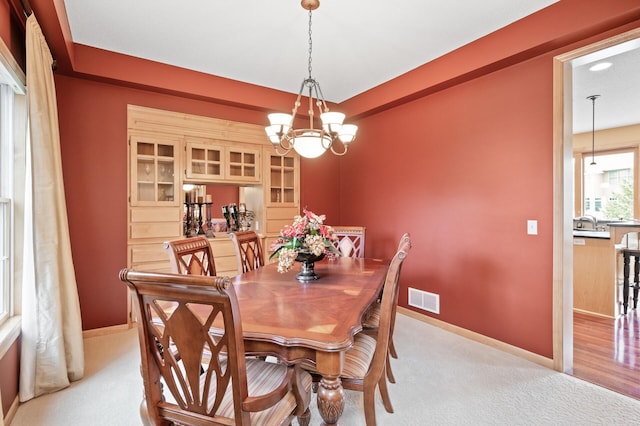 2469 Tournament Players Cir S, Blaine, MN 55449 - dining area featuring visible vents, baseboards, a chandelier, and light colored carpet