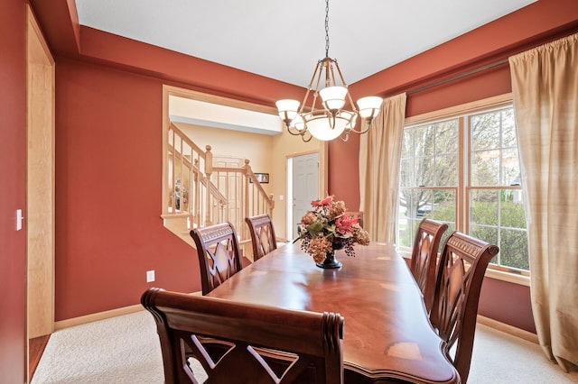 2469 Tournament Players Cir S, Blaine, MN 55449 - carpeted dining area with baseboards, an inviting chandelier, and stairway