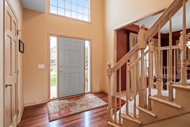 2469 Tournament Players Cir S, Blaine, MN 55449 - entrance foyer featuring baseboards, a high ceiling, and wood finished floors