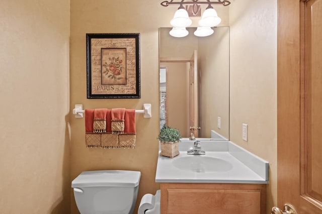 2469 Tournament Players Cir S, Blaine, MN 55449 - bathroom featuring vanity, toilet, and a chandelier