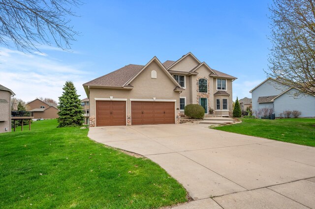 2469 Tournament Players Cir S, Blaine, MN 55449 - view of front of property with a garage, stucco siding, driveway, and a front yard