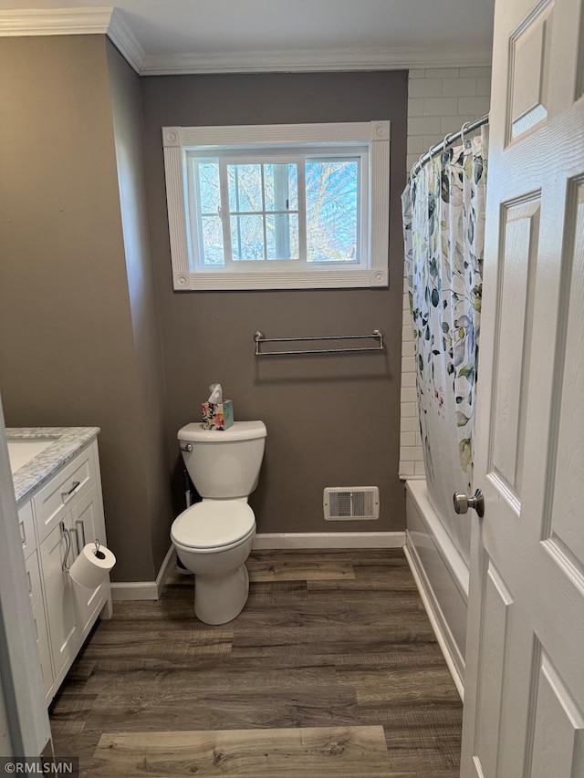 full bathroom with wood finished floors, visible vents, vanity, ornamental molding, and baseboards