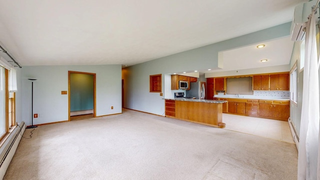 kitchen featuring appliances with stainless steel finishes, baseboard heating, brown cabinets, light carpet, and recessed lighting