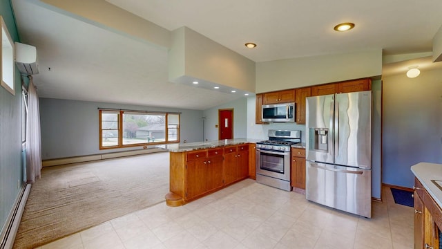 kitchen with appliances with stainless steel finishes, a peninsula, brown cabinetry, a baseboard heating unit, and light carpet