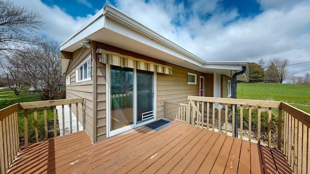 wooden deck featuring a lawn