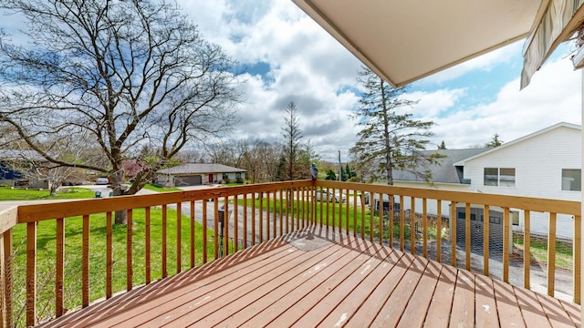 wooden deck featuring a yard