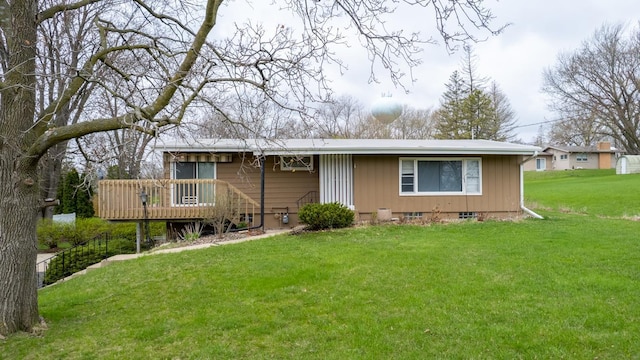 ranch-style house with a wooden deck and a front yard