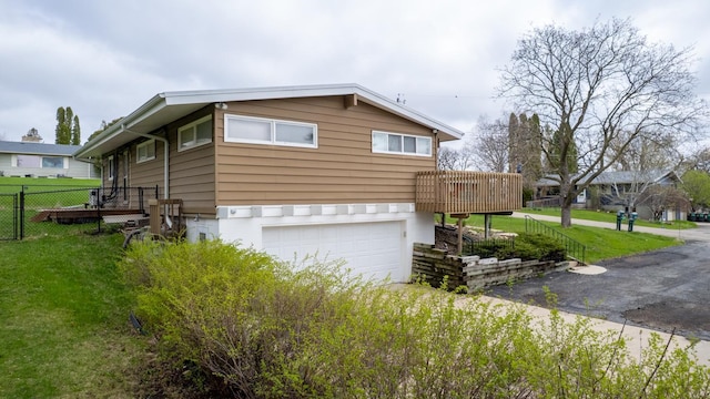 view of side of home featuring a garage and a wooden deck