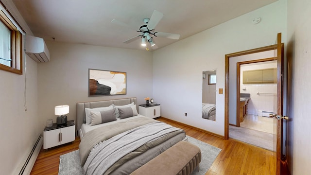 bedroom featuring baseboard heating, a wall mounted AC, wood finished floors, and ceiling fan