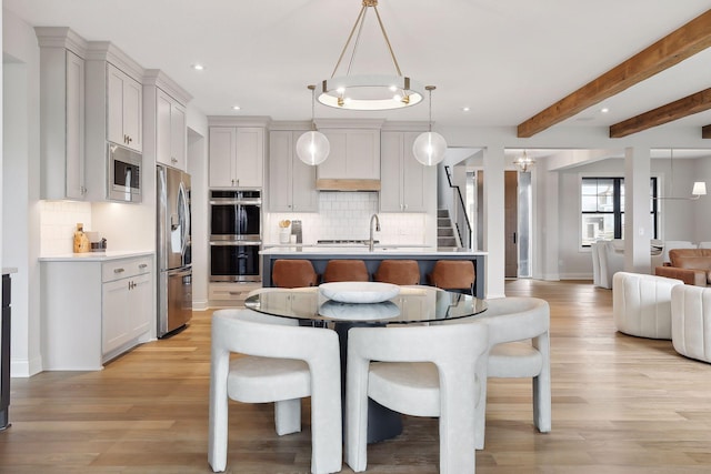 9511 Eagle Ridge Rd, Chanhassen, MN 55317 - kitchen with stainless steel appliances, open floor plan, light countertops, recessed lighting, and decorative backsplash