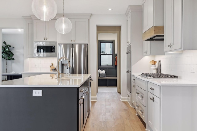9511 Eagle Ridge Rd, Chanhassen, MN 55317 - kitchen with stainless steel appliances, light countertops, light wood-style floors, tasteful backsplash, and recessed lighting