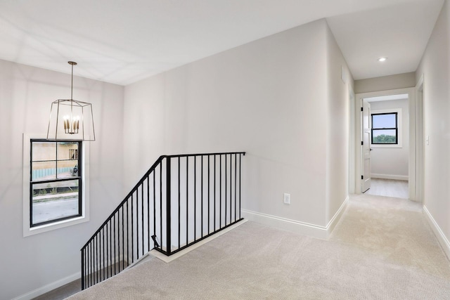9511 Eagle Ridge Rd, Chanhassen, MN 55317 - corridor with an upstairs landing, a chandelier, and carpet floors