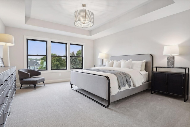 9511 Eagle Ridge Rd, Chanhassen, MN 55317 - bedroom with a tray ceiling, light carpet, and a chandelier