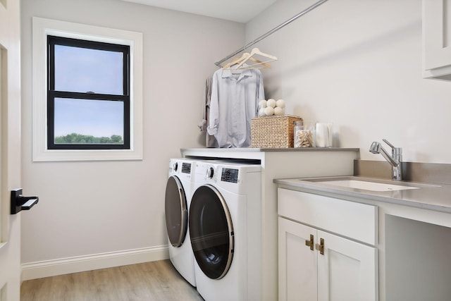 9511 Eagle Ridge Rd, Chanhassen, MN 55317 - washroom featuring washer and clothes dryer, cabinet space, and light wood-style floors