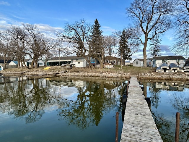 dock area featuring a residential view and a water view