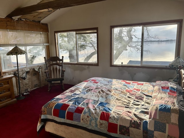 carpeted bedroom featuring vaulted ceiling with beams