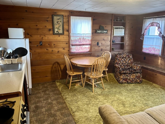 dining room with wood walls