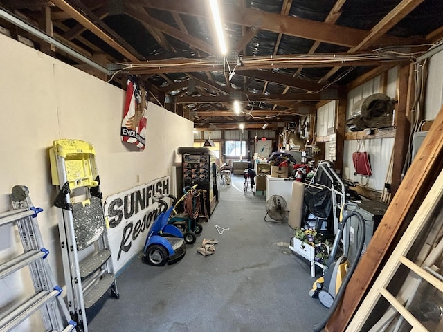 interior space featuring washer / dryer, a workshop area, and a garage