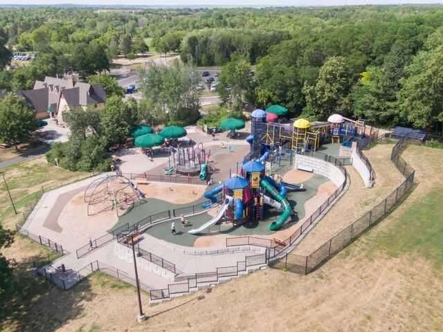 drone / aerial view with a wooded view