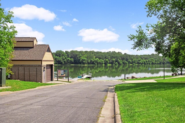 water view with a view of trees and a dock