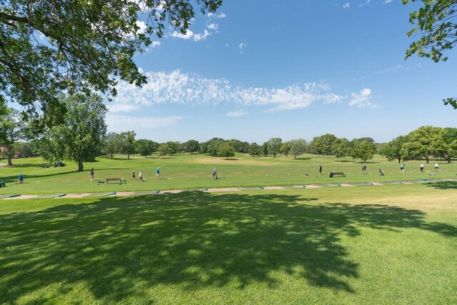 view of community featuring a yard and golf course view