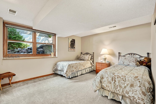 bedroom featuring baseboards, carpet, a textured ceiling, and visible vents