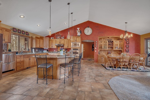 26182 Jericho Rd, Saint Joseph Twp, MN 56301 - kitchen featuring stainless steel appliances, a breakfast bar area, stone tile flooring, a chandelier, and pendant lighting