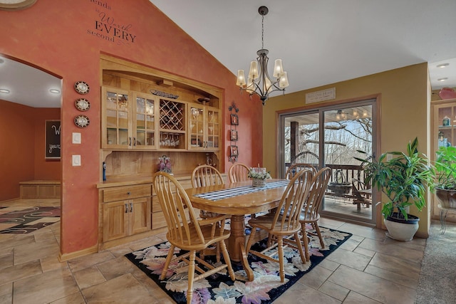 26182 Jericho Rd, Saint Joseph Twp, MN 56301 - dining room featuring arched walkways, a chandelier, stone tile flooring, baseboards, and high vaulted ceiling