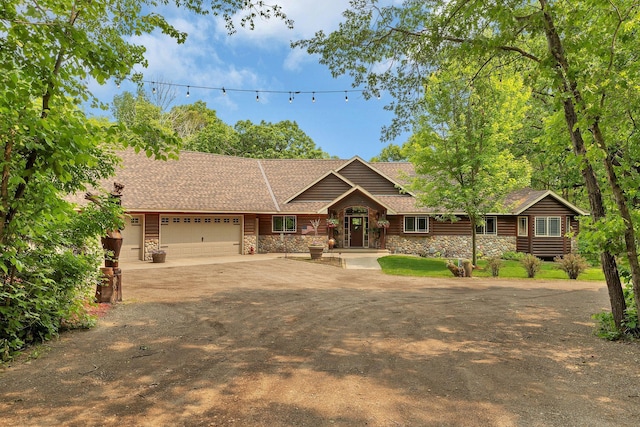 26182 Jericho Rd, Saint Joseph Twp, MN 56301 - view of front of house with stone siding, a garage, dirt driveway, and a shingled roof