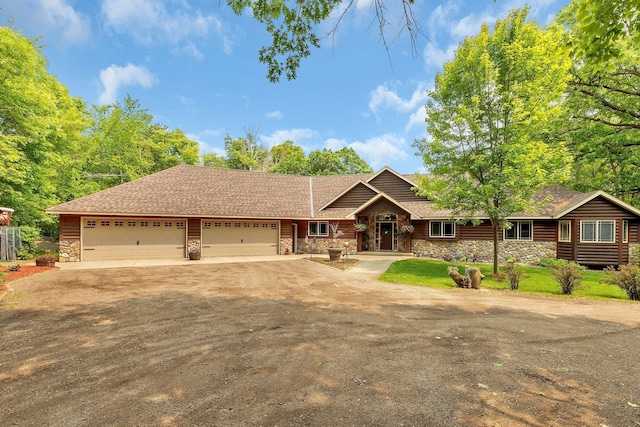 26182 Jericho Rd, Saint Joseph Twp, MN 56301 - view of front of house featuring stone siding, driveway, and a garage