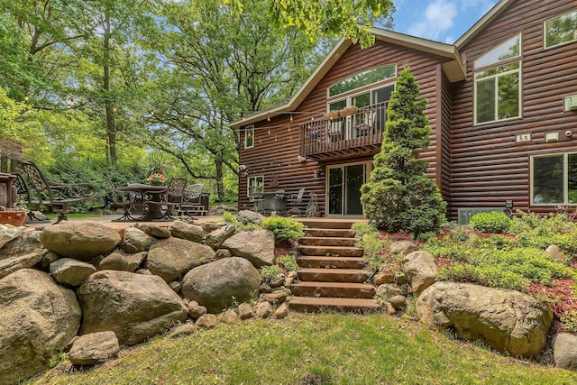 26182 Jericho Rd, Saint Joseph Twp, MN 56301 - back of house with a balcony, faux log siding, and a patio area