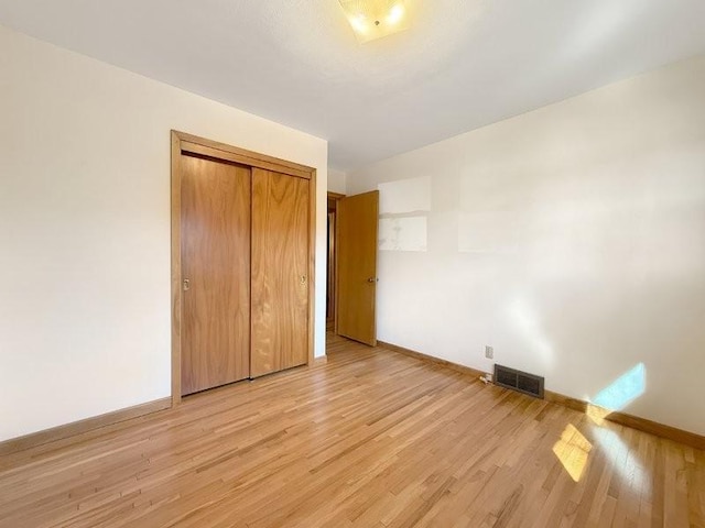 1254 State St, Fairmont, MN 56031 - unfurnished bedroom with baseboards, a closet, visible vents, and light wood-type flooring
