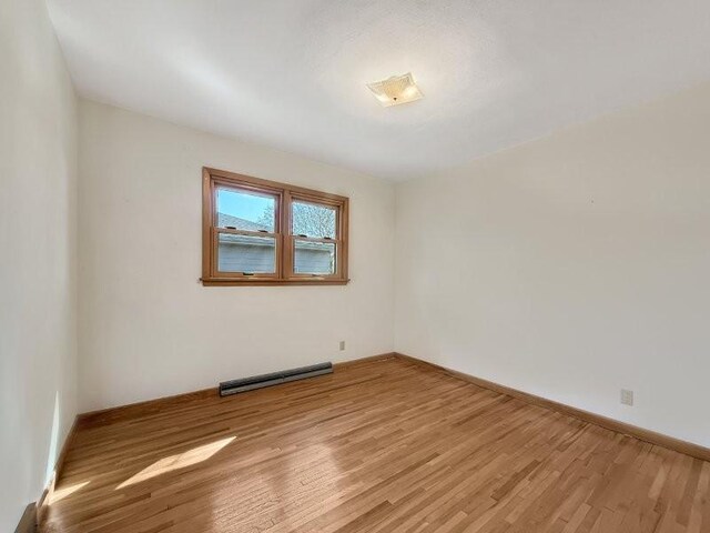 1254 State St, Fairmont, MN 56031 - spare room featuring visible vents, light wood-style flooring, and baseboards