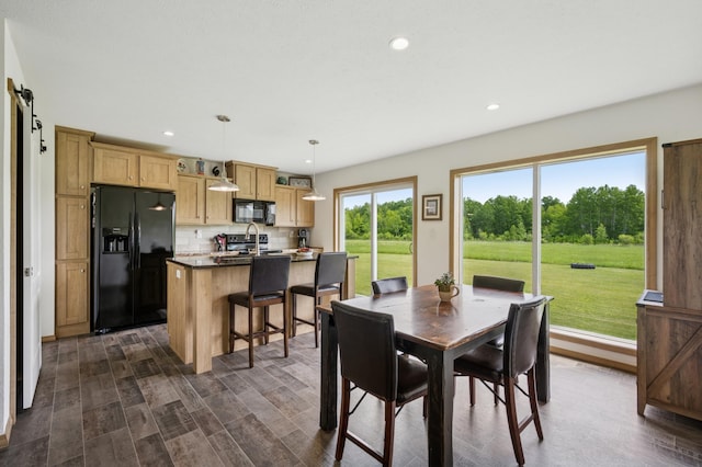 18394 145th Ave, Milaca, MN 56353 - dining area featuring recessed lighting, a barn door, and dark wood-style flooring