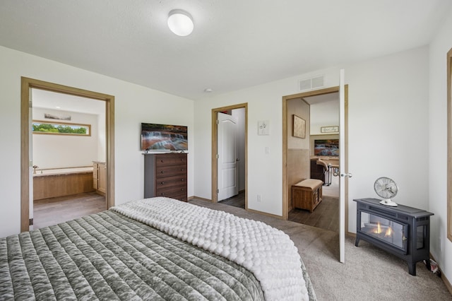 18394 145th Ave, Milaca, MN 56353 - bedroom featuring light colored carpet, ensuite bathroom, and baseboards