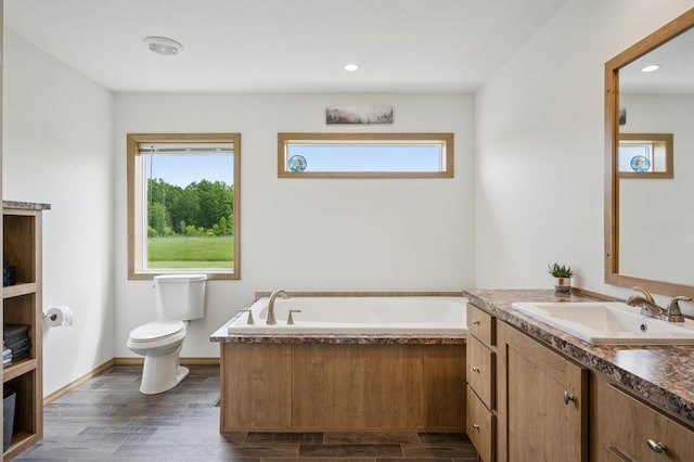 18394 145th Ave, Milaca, MN 56353 - full bath with vanity, plenty of natural light, a garden tub, toilet, and recessed lighting