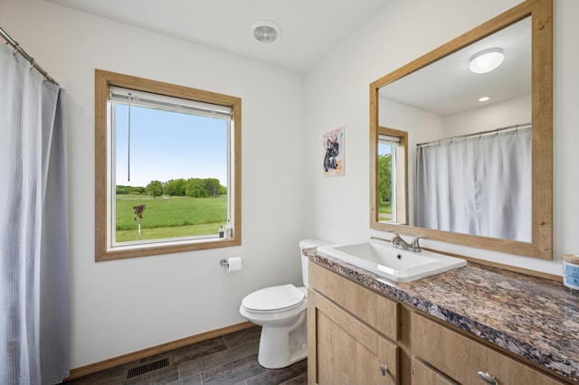 18394 145th Ave, Milaca, MN 56353 - bathroom with vanity, toilet, wood finished floors, baseboards, and curtained shower