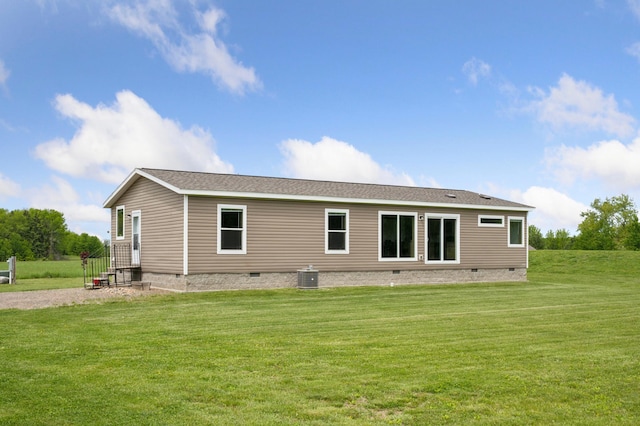 18394 145th Ave, Milaca, MN 56353 - rear view of house with crawl space, a yard, and cooling unit
