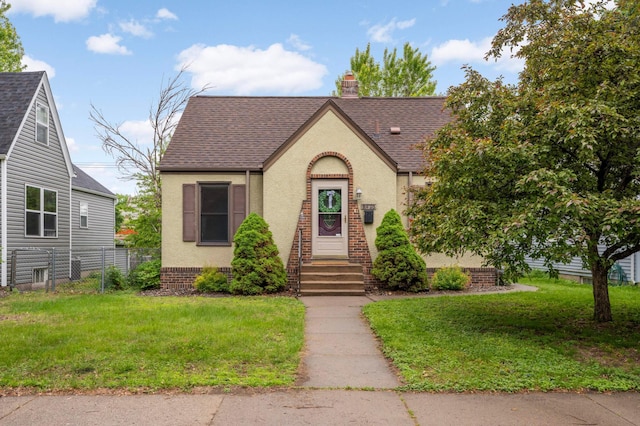 5425 Aldrich Ave S, Minneapolis, MN 55419 - tudor-style house featuring a shingled roof, stucco siding, and a chimney