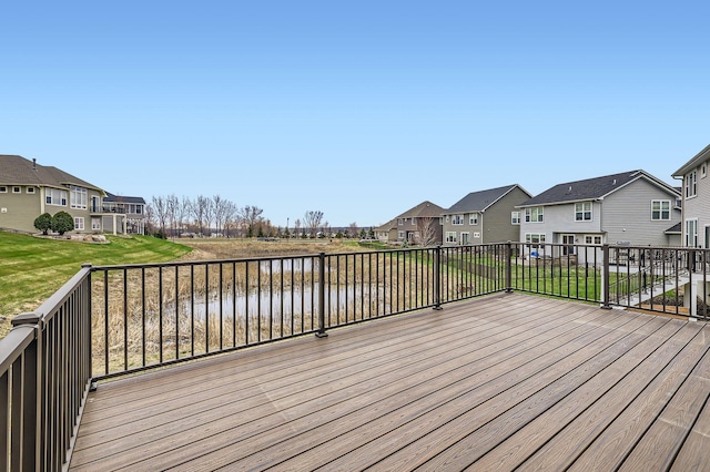 wooden deck featuring a water view, a yard, and a residential view