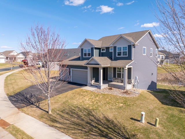 view of front of home featuring a front lawn, covered porch, and driveway