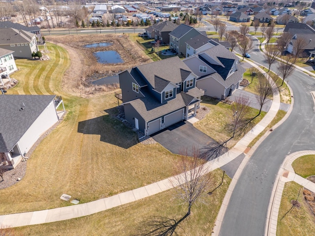 birds eye view of property with a water view and a residential view